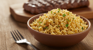 Texas Roadhouse seasoned rice served in a rustic bowl with herbs and spices on a wooden table
